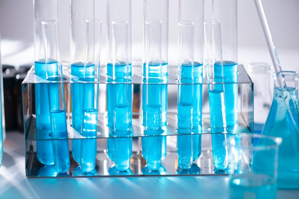 pexels-photo-2280549-2280549 Close-up of blue liquid in test tubes for chemistry experiments in a laboratory setting.